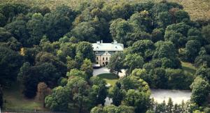 an aerial view of a house in the forest at Palac w Rybnej in Rybna