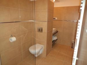 a bathroom with a toilet and a glass shower at Siedem Świerków in Szczecinek +28 photos