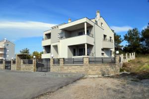a white building on top of a stone wall at Apartments Miočić in Zadar