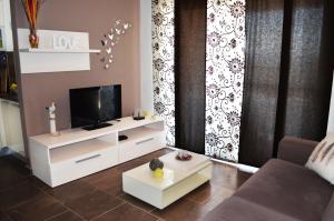 a living room with a tv and a couch at Apartments Miočić in Zadar