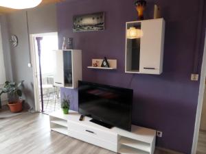 a living room with a flat screen tv on a white entertainment center at Apartmán Trutnov in Trutnov