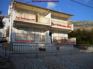 a white building with two balconies on it at Apartments Dunja Hvar in Ivan Dolac