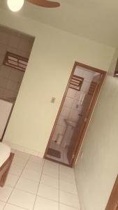 an empty room with a large glass door in a building at Pousada da Nalva in Rio das Ostras