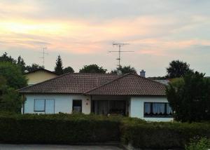 a white house with a brown roof at Ferienhaus Tettenweis in Tettenweis