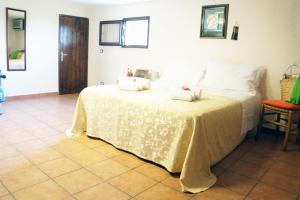 a bedroom with a white bed with two pillows on it at Casa Vacanza da Sara in Custonaci