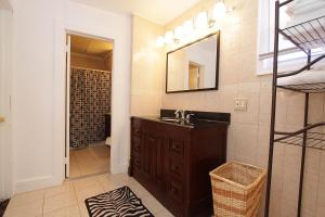 a bathroom with a sink and a mirror at Shore Beach Houses - 40 - 1 Dupont Ave in Seaside Heights