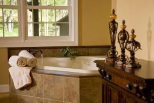 a bath tub in a bathroom with a window at Goldmoor Inn & Resort in Galena