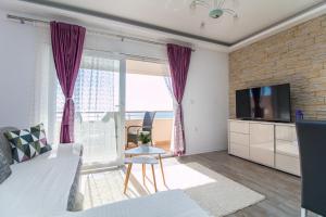 a living room with a bed and a tv at Apartments Rakuljic in Podstrana