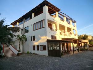 a large white building with a lot of windows at Mediterraneo Mare e Sole in Marina di Palma