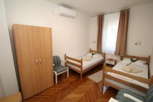 mały pokój z 2 łóżkami i szafką w obiekcie Apartment Adriatic Gem w Splicie