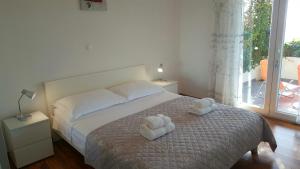 a bedroom with a bed with two towels on it at Apartment Mia in Hvar