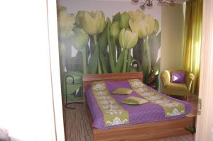 a bedroom with a bed and a painting of tulips at Kate Sea Apartment in Pärnu