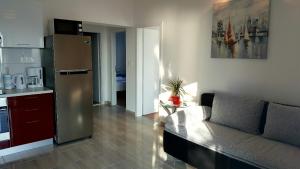a kitchen and a living room with a couch and a refrigerator at Apartment Mia in Hvar