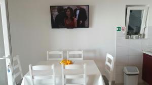 a kitchen with a white table and white chairs at Apartment Mia in Hvar