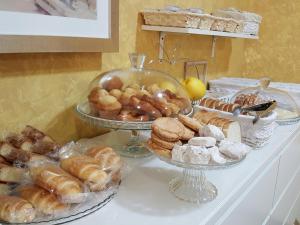 a buffet filled with different types of bread and pastries at HOTEL RURAL San Pedro in Frómista