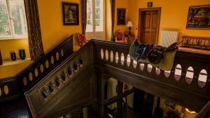 a hallway with a wooden railing with a bag on it at Schloss Stülpe in Stülpe +58 photos