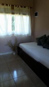 a bedroom with a white bed and a window at Nuestro Sueño in Tandil