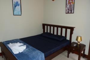 a small bedroom with a blue bed with a night stand at Hotel La Gran Sultana in Granada