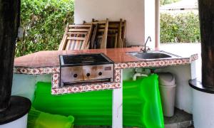 a kitchen with a stove and a sink at Apartment in Hermosa's gardens in Playa Hermosa