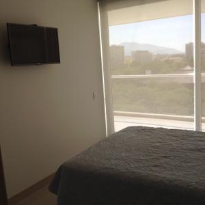Apartamento Bello Horizonte tesisinde bir odada yatak veya yataklar