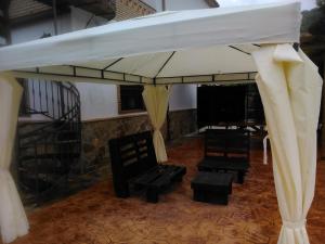 a tent with chairs and a stage with curtains at Alojamiento Rural la Veguetilla in Frailes