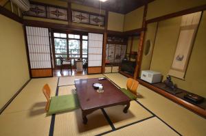 a room with a table and chairs in a room at Asanokan in Ise