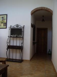 a living room with a flat screen tv on a wall at Alojamiento Rural la Veguetilla in Frailes
