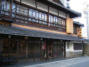 an asian building with a bench in front of it at Asanokan in Ise