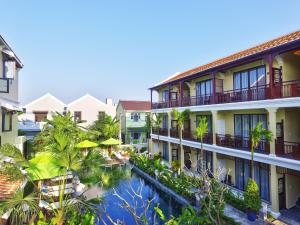 a view of the courtyard of a hotel with a swimming pool at Hoi An Field Boutique Resort & Spa in Hoi An