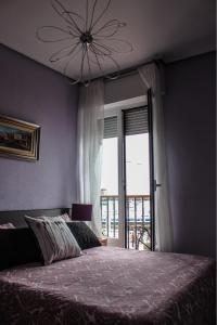 a bedroom with a bed and a large window at Villa Floren Castro Urdiales in Castro-Urdiales
