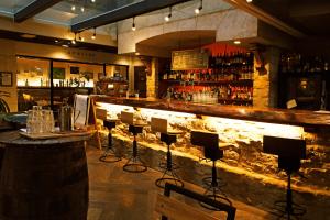 a bar with a row of stools in a restaurant at Hostel Cuore Kurashiki in Kurashiki