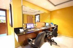 ein Büro mit einem Schreibtisch mit einem Computer und 2 Stühlen in der Unterkunft Nova Gold Hotel Pattaya in Pattaya