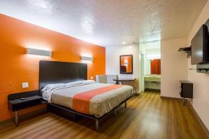 a large room with a bed and a television at Motel 6-Madisonville, TX in Madisonville