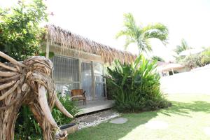 a house with a window and a chair in the yard at Sal Secret Spot in Uluwatu