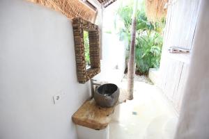 a bathroom with a sink and a mirror on the wall at Sal Secret Spot in Uluwatu +37 photos