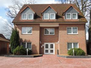 a brick house with a brick driveway at Hotel Stadt Munster in Munster