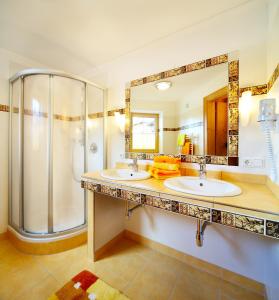 a bathroom with two sinks and a shower at Appartements Castello in Königsleiten