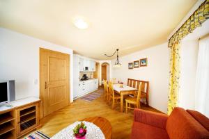 a kitchen and living room with a table and a dining room at Appartements Castello in Königsleiten