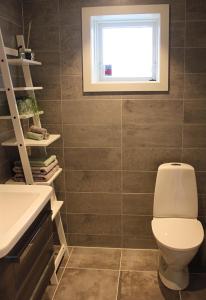 a bathroom with a toilet and a window at City View Studio Apartment in Ålesund