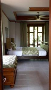 a bedroom with two beds and a window at 3 Bedroom Villa TG11 on Beachfront Resort SDV280-By Samui Dream Villas in Ban Tai