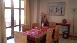 a dining room with a wooden table and chairs at 3 Bedroom Villa TG11 on Beachfront Resort SDV280-By Samui Dream Villas in Ban Tai