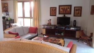 a living room with a couch and a tv at 3 Bedroom Villa TG11 on Beachfront Resort SDV280-By Samui Dream Villas in Ban Tai