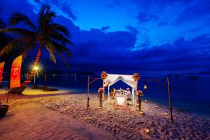 a wedding altar on the beach at night at Secret Garden Beach Resort in Bangrak Beach