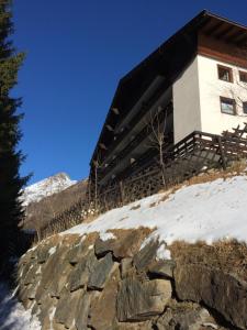 a building on top of a snow covered mountain at Berghaus Glockner, App. Niedermeyer in Heiligenblut