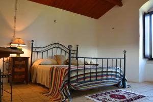 a bedroom with a black bed with a blanket on it at B&B Masseria del Marchese in Castellana Grotte