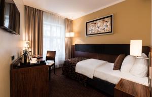Postel nebo postele na pokoji v ubytování Avalon Hotel & Conferences + 37 fotografií