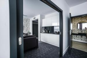 a living room with a couch and a kitchen at Hotel Europa Starachowice in Starachowice