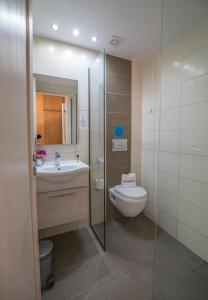 a bathroom with a toilet and a sink at Kordistos Hotel in Kefalos