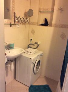 a bathroom with a washing machine and a sink at Appartment Nezamyslova II in Prague