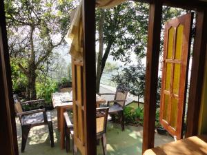 an open door to a patio with a table and chairs at Bel View Guest House in Haputale